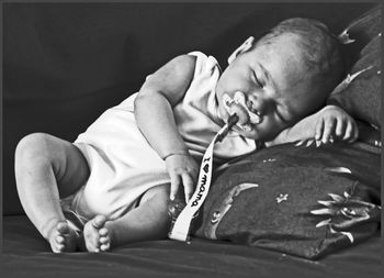 Full length of baby sleeping on sofa at home