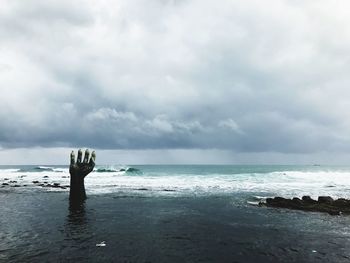Hand sculpture in sea