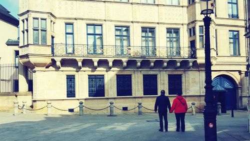 Rear view of man walking in building