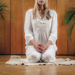 Woman practicing kundalini yoga, kriya exercises for the navel center and bowel waste elimination