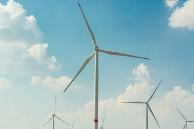 Low angle view of windmill against sky