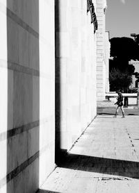 Man walking in front of building