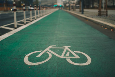 Close-up of arrow symbol on road in city