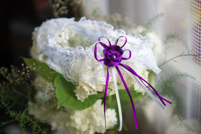 Close-up of wedding garter with purple ribbon