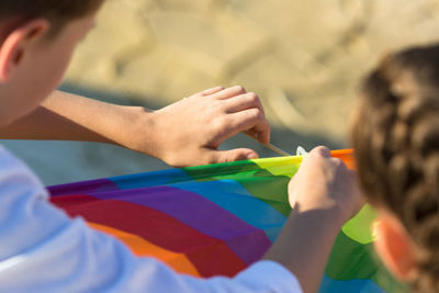 Cropped hand of woman painting