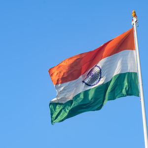 India flag flying high at connaught place with pride in blue sky, india flag fluttering, indian flag