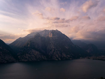 Scenic view of lake by mountains against sky