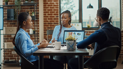 Side view of business colleagues working at office