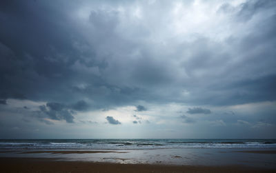 Scenic view of sea against storm clouds