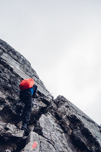 Low angle view of man on snow against sky