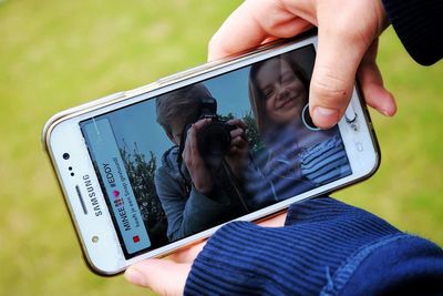 Midsection of man using mobile phone