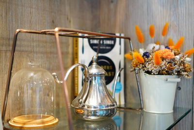 Close-up of flowers in glass container on table