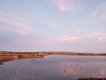 Scenic view of lake against sky during sunset