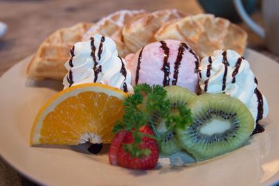 Close-up of fruits with dessert in plate