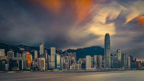 Modern buildings in city against sky at night