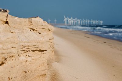 Scenic view of beach against clear sky