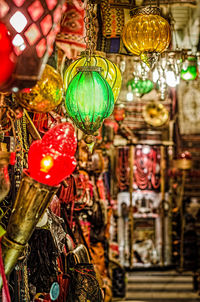 Close-up of illuminated lanterns hanging at market