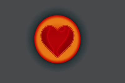 Close-up of red heart shape over black background