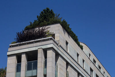 Low angle view of building against clear blue sky