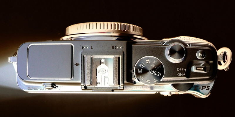 CLOSE-UP OF CAMERA ON MIRROR AGAINST BLURRED BACKGROUND