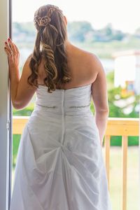 Rear view of bride standing at balcony