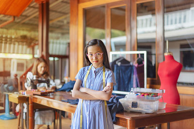 Portrait of a smiling young woman standing on table