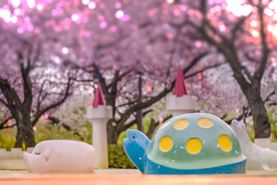 Cute pig, turtle and seal sculptures looking at the cherry blossoms of asukayama park in tokyo.