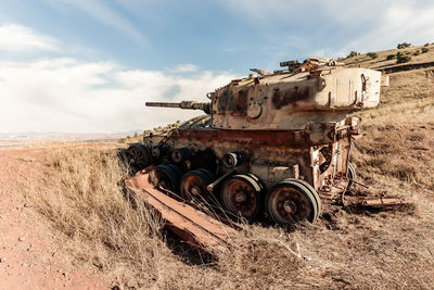 Abandoned vehicle on field