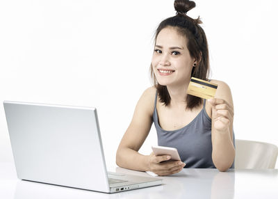 Portrait of smiling young woman using smart phone