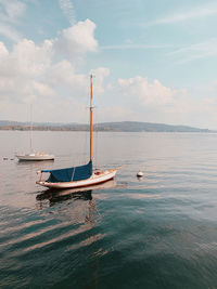 Sailboat sailing on sea against sky