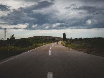 Road amidst trees against sky