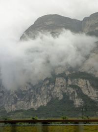 Scenic view of land and mountains against sky