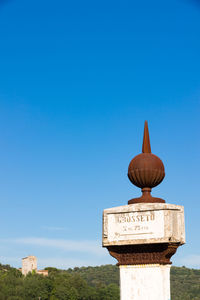 Low angle view of clock tower against clear blue sky