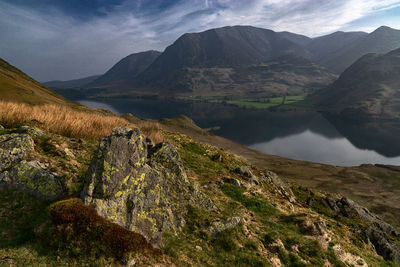 Scenic view of lake and mountains against sky