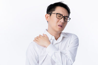 Mid adult man standing against white background