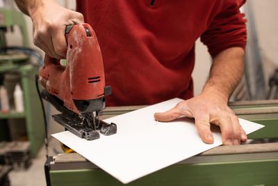 Midsection of man working in workshop