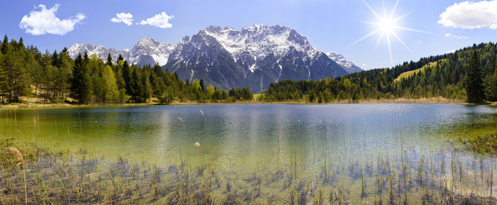 Scenic view of lake and mountains against sky