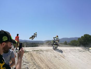 Man on motorcycle against clear sky