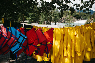 Life jackets and raincoat hanging on rope