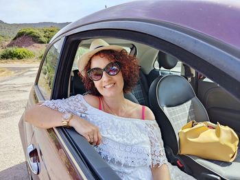 Portrait of smiling young woman in car