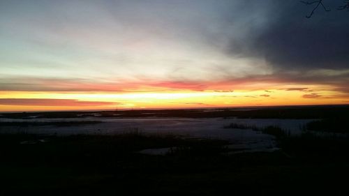 Scenic view of beach against sky during sunset