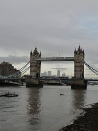 View of bridge over river against cloudy sky