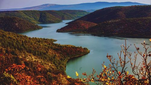 Scenic view of lake and mountains against sky