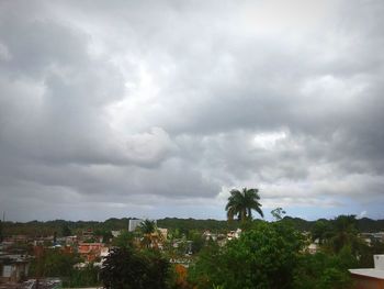 View of townscape against cloudy sky