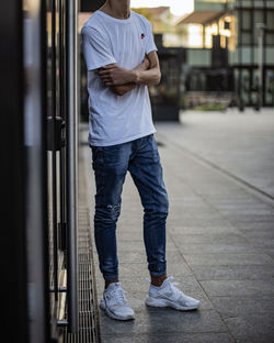 Low section of man standing on railroad track