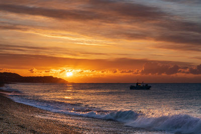 Scenic view of sea against sky during sunrise