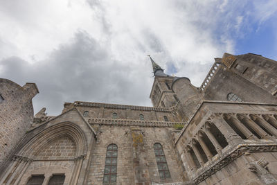 Low angle view of cathedral against cloudy sky