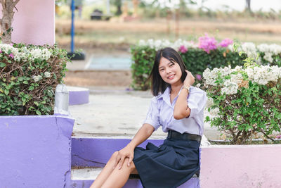 Portrait of school girl sitting in garden