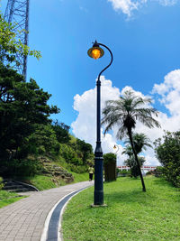 Street light by road against sky