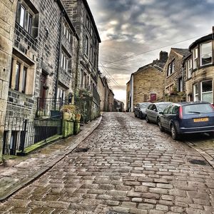 Street amidst houses against sky